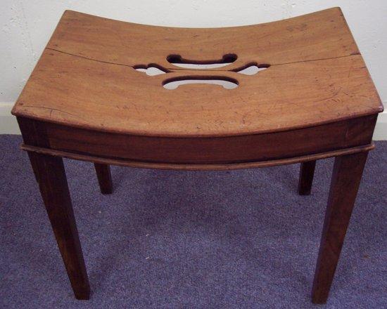 Appraisal: A mid th Century stool with pierced saddle type top