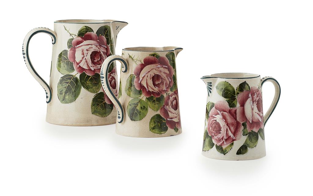 Appraisal: WEMYSS WARE THREE 'CABBAGE ROSES' GRADUATED MILK JUGS EARLY TH