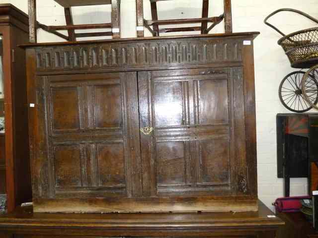 Appraisal: AN OLD OAK CUPBOARD with polished top arcarde carved frieze