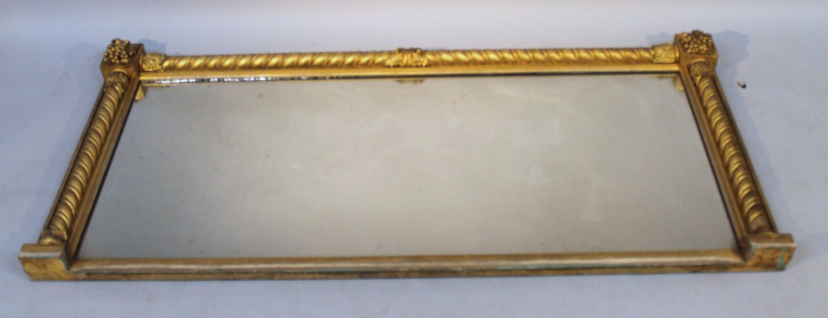 Appraisal: A thC gilt wood oval mantel mirror the rectangular glass