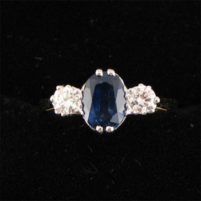 Appraisal: A sapphire and diamond three stone ring the oval shaped