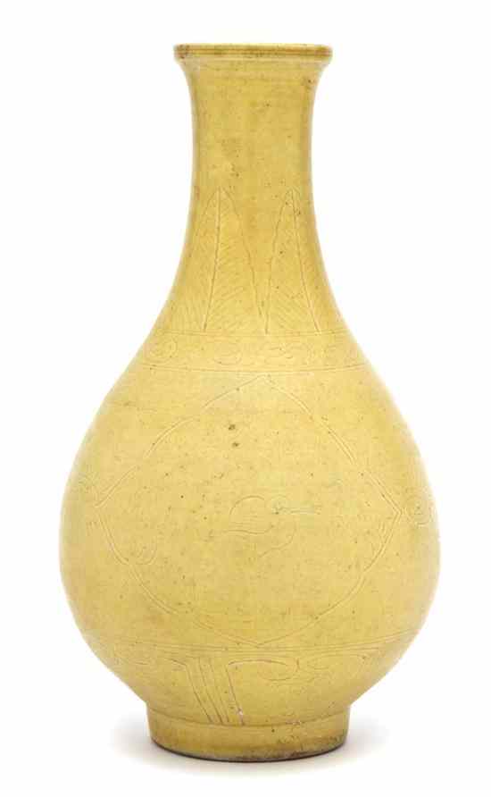 Appraisal: A Chinese Yellow Glazed Bottle Vase having carved decoration on