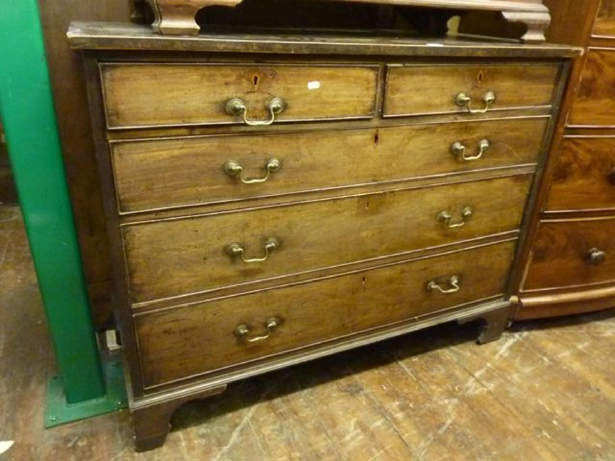 Appraisal: A Georgian flat fronted chest fitted with three long and