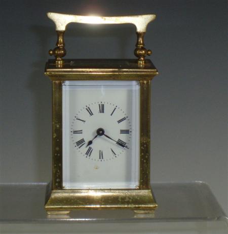 Appraisal: A small brass carriage clock with white enamel dial and