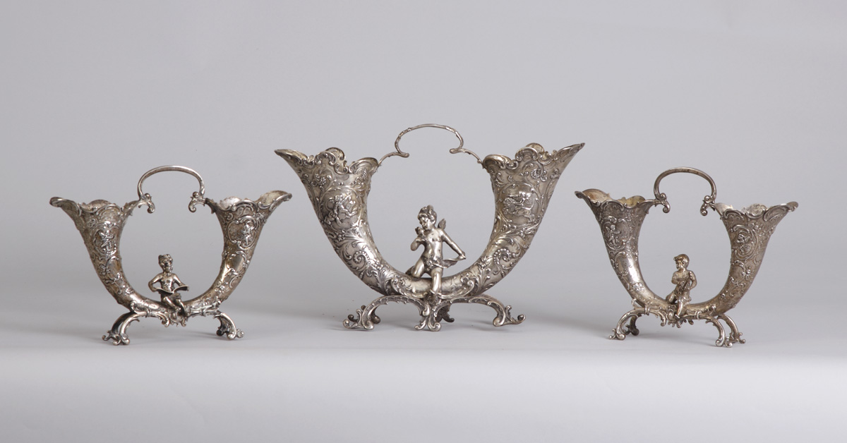 Appraisal: - German Silver Cornucopias Cast and chased with cherub floral