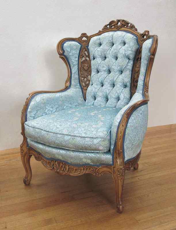 Appraisal: DEUTCH BROTHERS HEAVILY CARVED WINGBACK CHAIR Profusely carved with figural