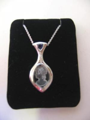 Appraisal: AN IOLITE DIAMOND AND CRYSTAL PENDANT the crystal intaglio carved