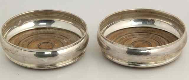 Appraisal: A pair of silver wine coasters London of plain circular