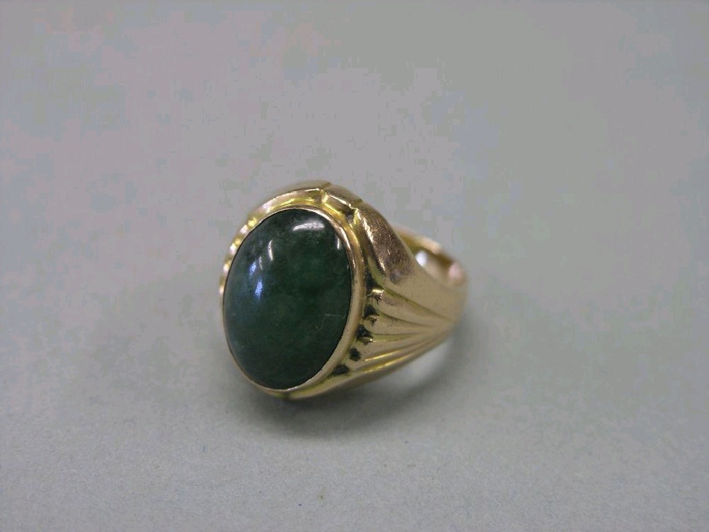 Appraisal: An ct gold ring set oval jade cabochon ring size