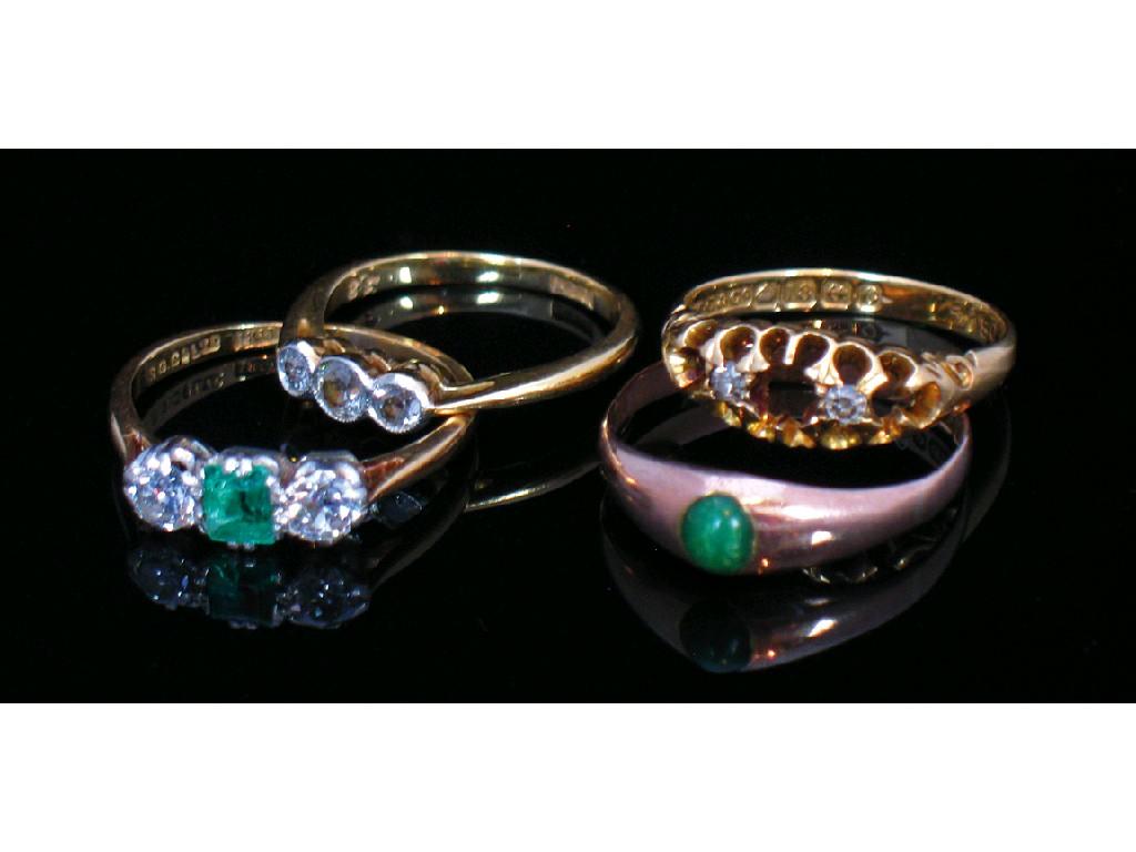 Appraisal: AN EMERALD AND DIAMOND THREE STONE DRESS RING mounted in