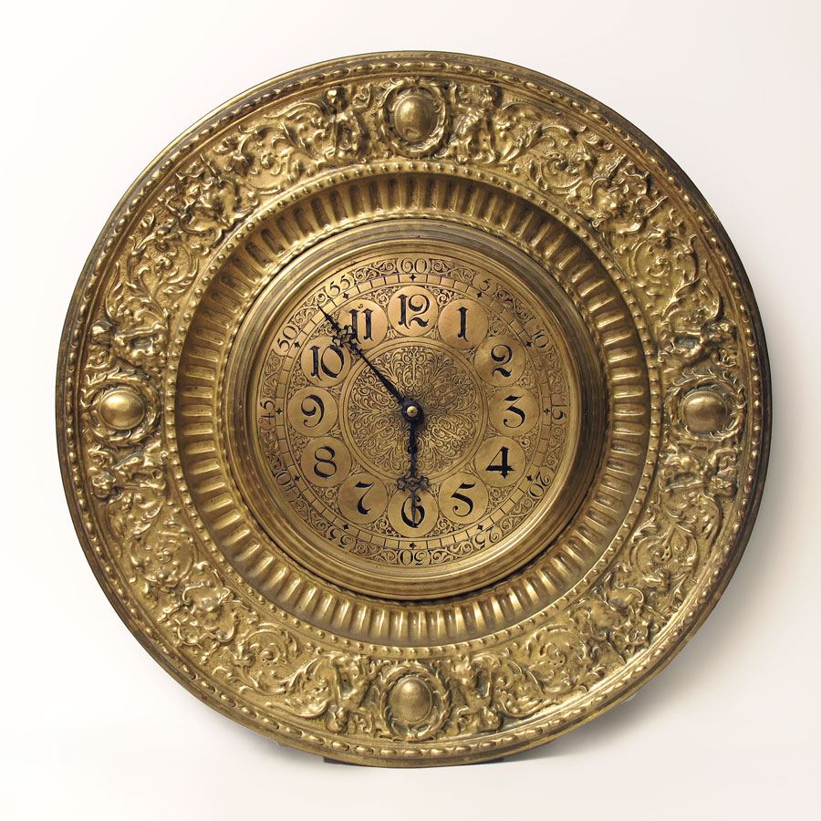 Appraisal: GERMAN BRASS PLATE EMBOSSED WALL CLOCK Embossed frame featuring cherubs