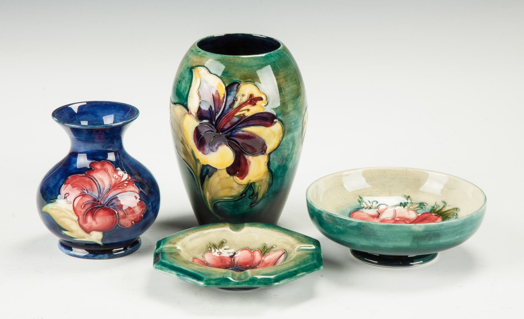 Appraisal: Group of Moorcroft Vase w hibiscus Vase w lily Ashtray