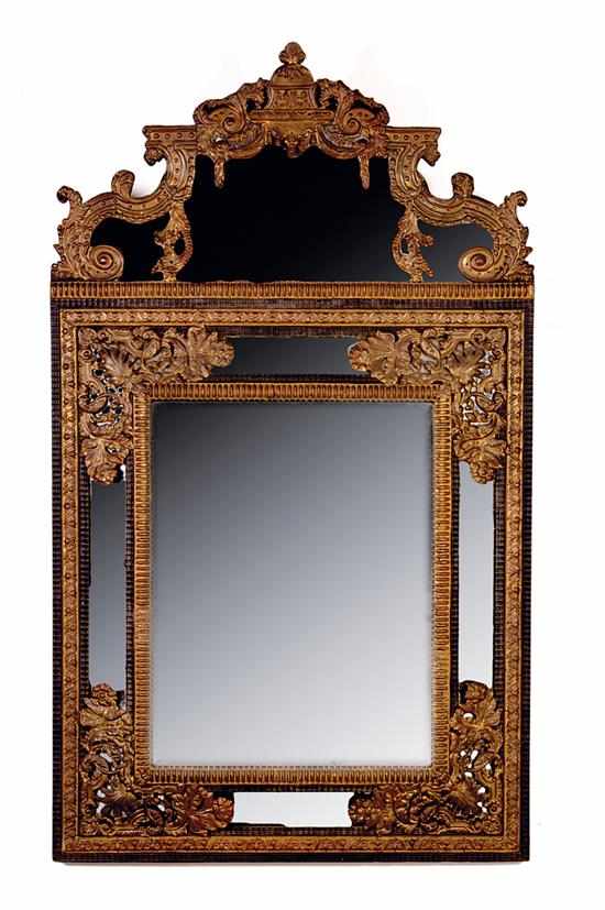 Appraisal: Continental ebonized wood and brass cushion mirror circa shaped crown