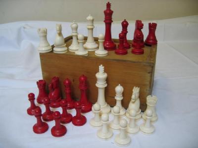 Appraisal: A STAUNTON IVORY FULL CHESS SET part red stained King