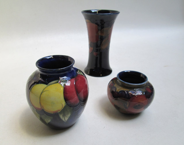 Appraisal: THREE MOORCROFT POTTERY VASES hand painted underglaze in the Pomegranate