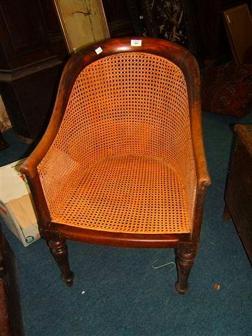 Appraisal: A Regency mahogany bergere library chair with caned back sides