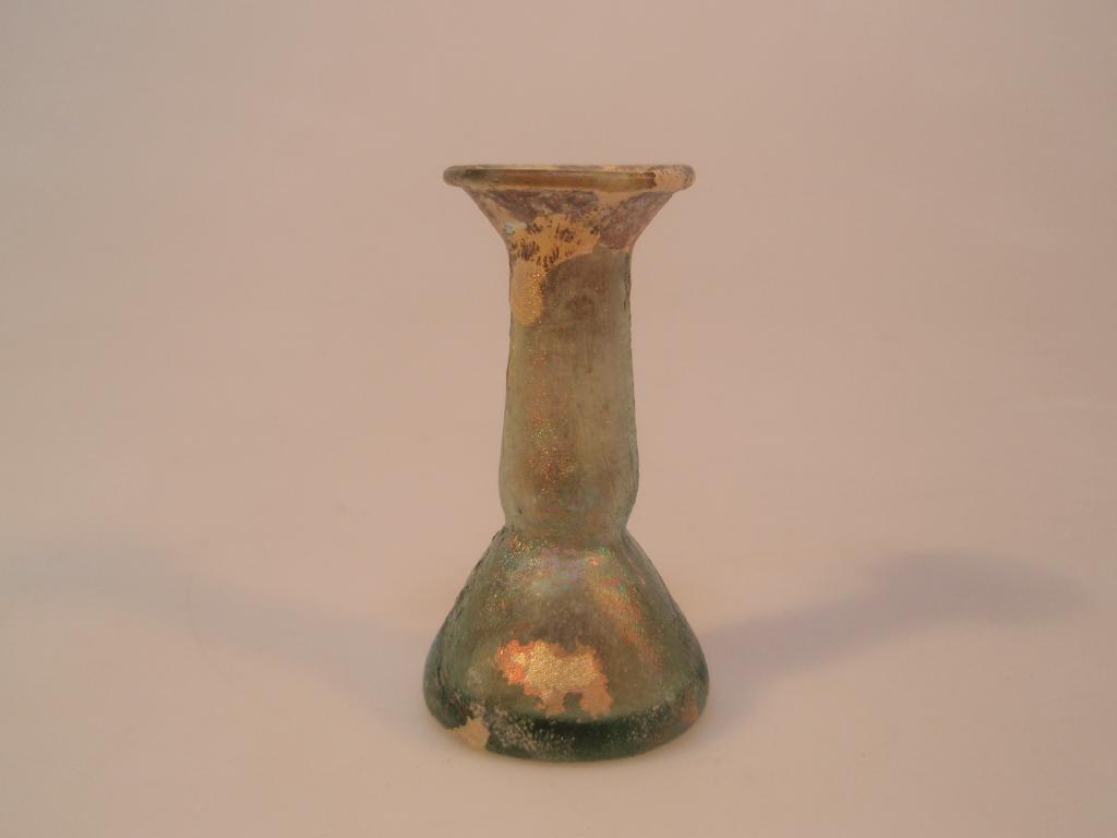 Appraisal: A heavy and squat light green Roman glass 'candlestick' unguentarium