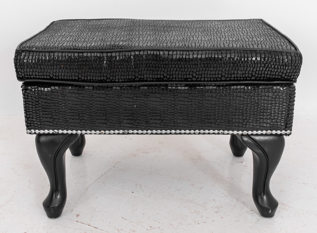 Appraisal: FAUX SNAKESKIN BLACK OTTOMAN Black faux snakeskin upholstered ottoman decorated