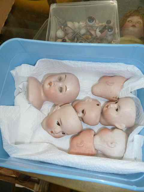 Appraisal: SEVEN DUMP DUG BISQUE DOLLS HEADS together with a quantity