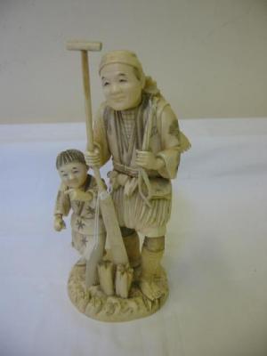 Appraisal: A JAPANESE CARVED IVORY OKIMONO depicting a fisherman and his