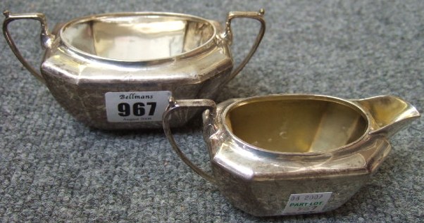 Appraisal: A silver twin handled sugar bowl of faceted design and