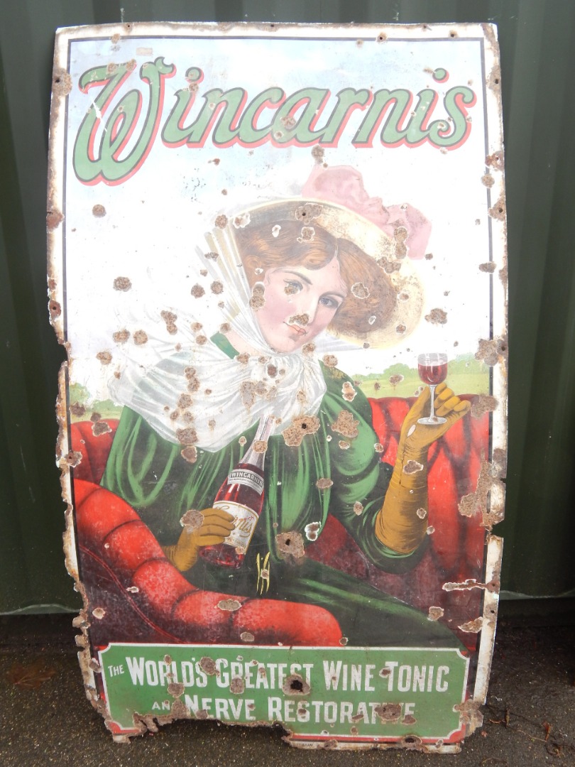 Appraisal: A Wincarnis enamel sign depicting a lady in a motor