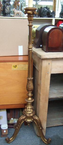 Appraisal: A giltwood standard lamp with leaf clasped baluster supports and