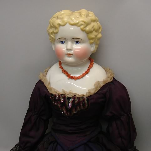 Appraisal: Unmarked china head doll with blue eyes short curly hair