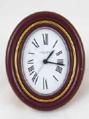 Appraisal: A Cartier oval bedside alarm clock with strut back and