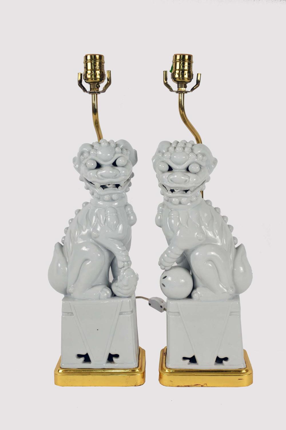 Appraisal: PAIR OF CHINESE BLANC-DE-CHINE PORCELAIN FU-DOGSTable Lamps One poised with