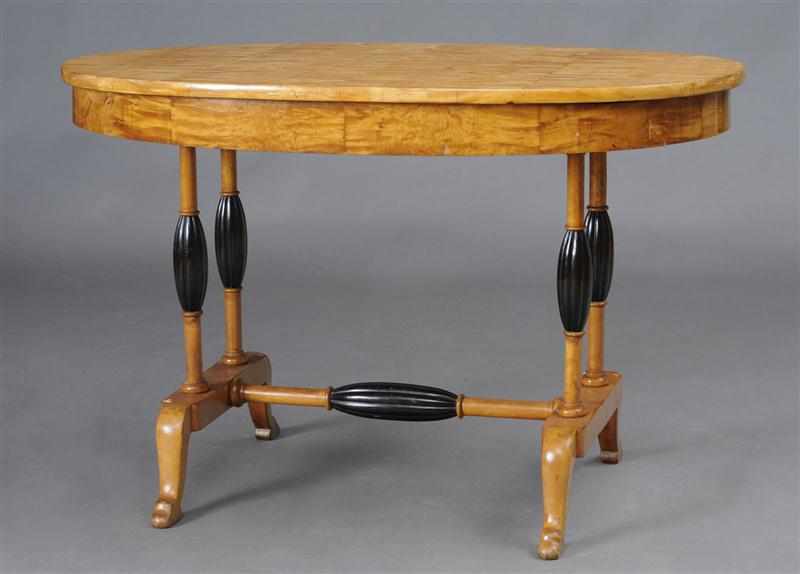 Appraisal: BIEDERMEIER STYLE SATINWOOD AND EBONIZED LIBRARY TABLE The oval top