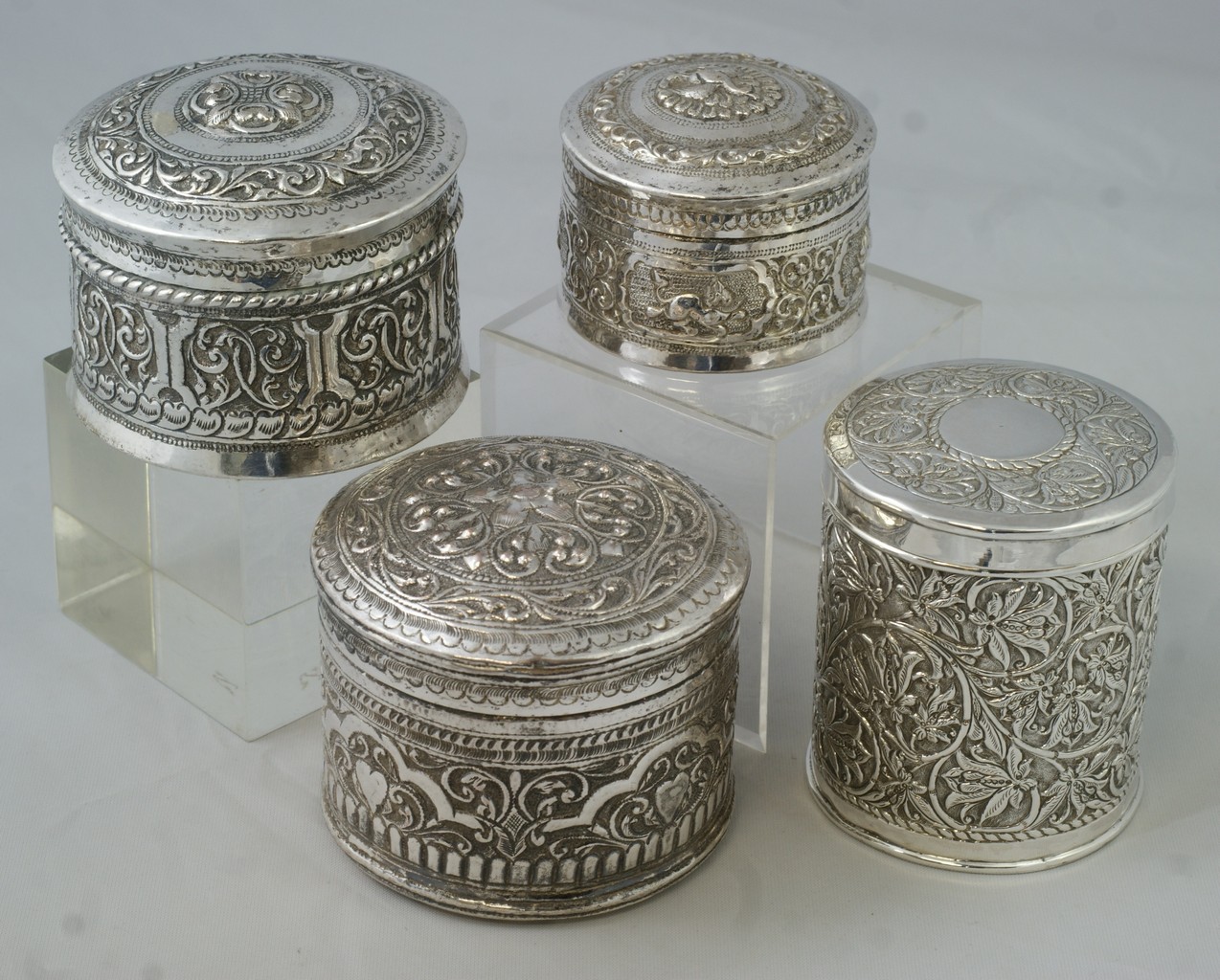 Appraisal: Indian Silver round boxes decorated with vines and mythical animals