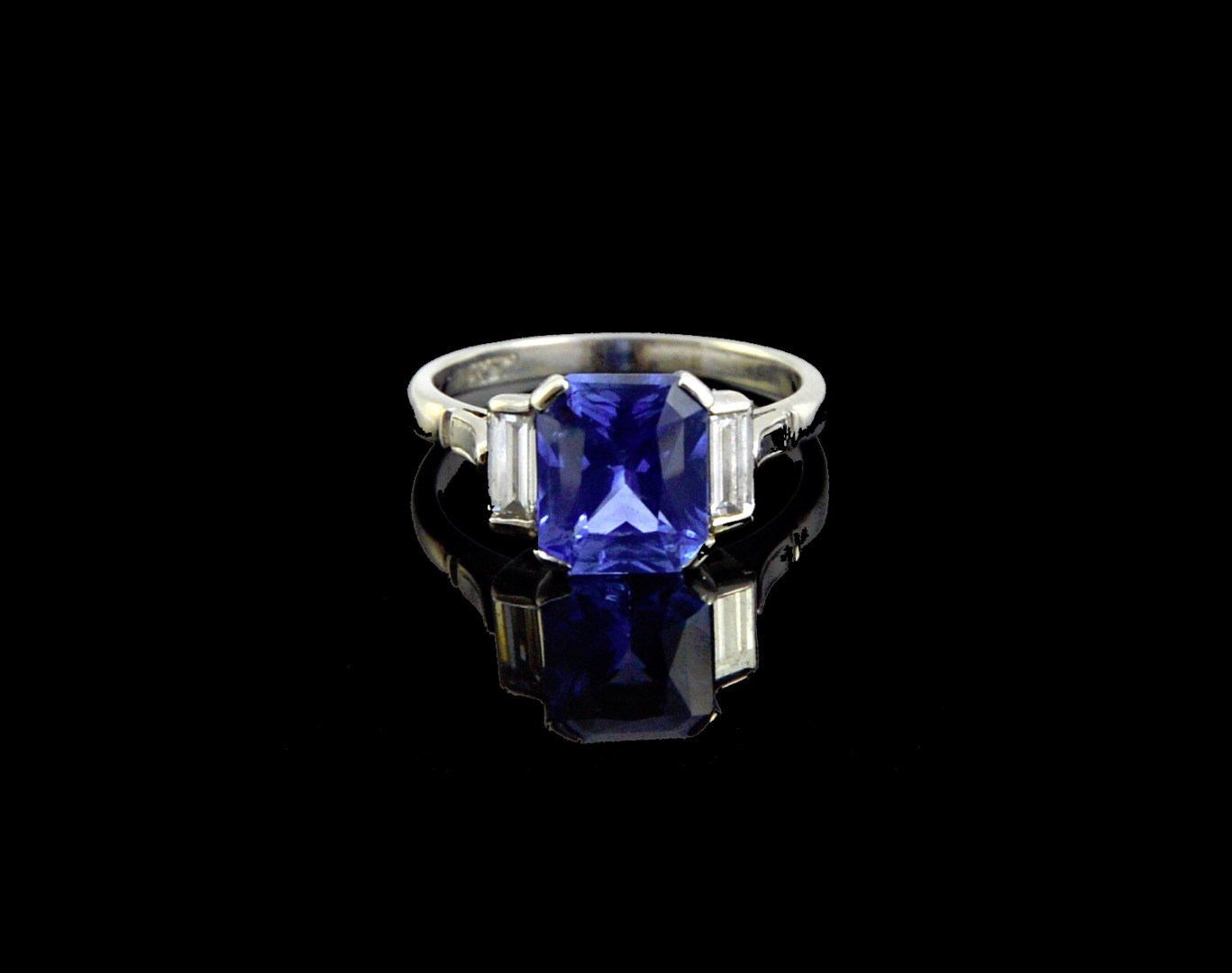 Appraisal: A platinum sapphire and diamond set three stone ring claw