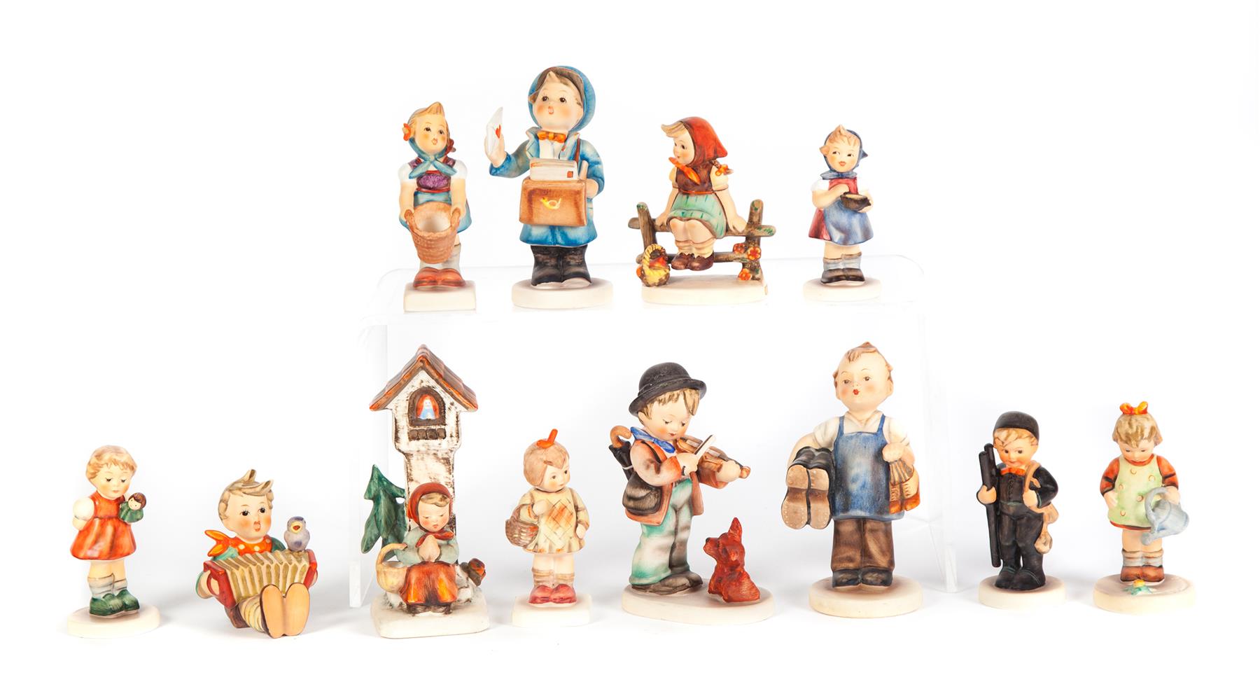 Appraisal: TWELVE HUMMEL FIGURINES Germany th and st centuries Group includes