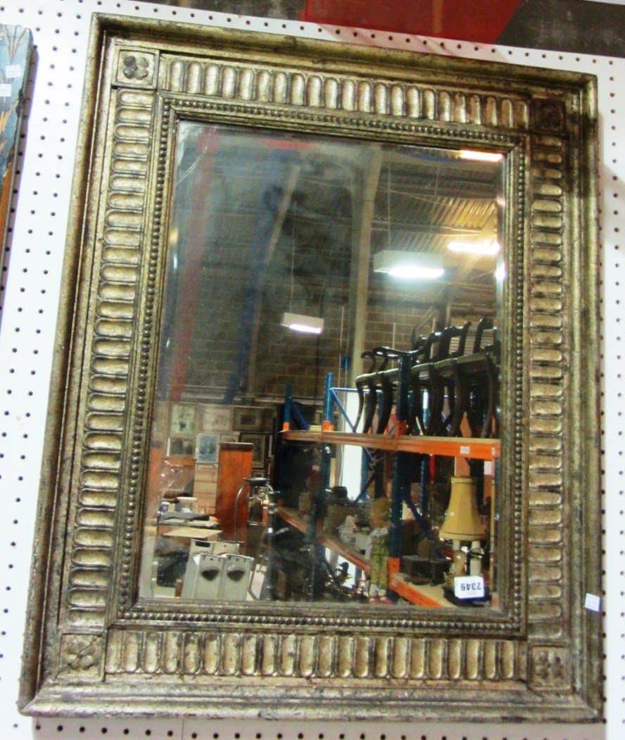 Appraisal: A th century silver painted pine rectangular mirror with bevelled