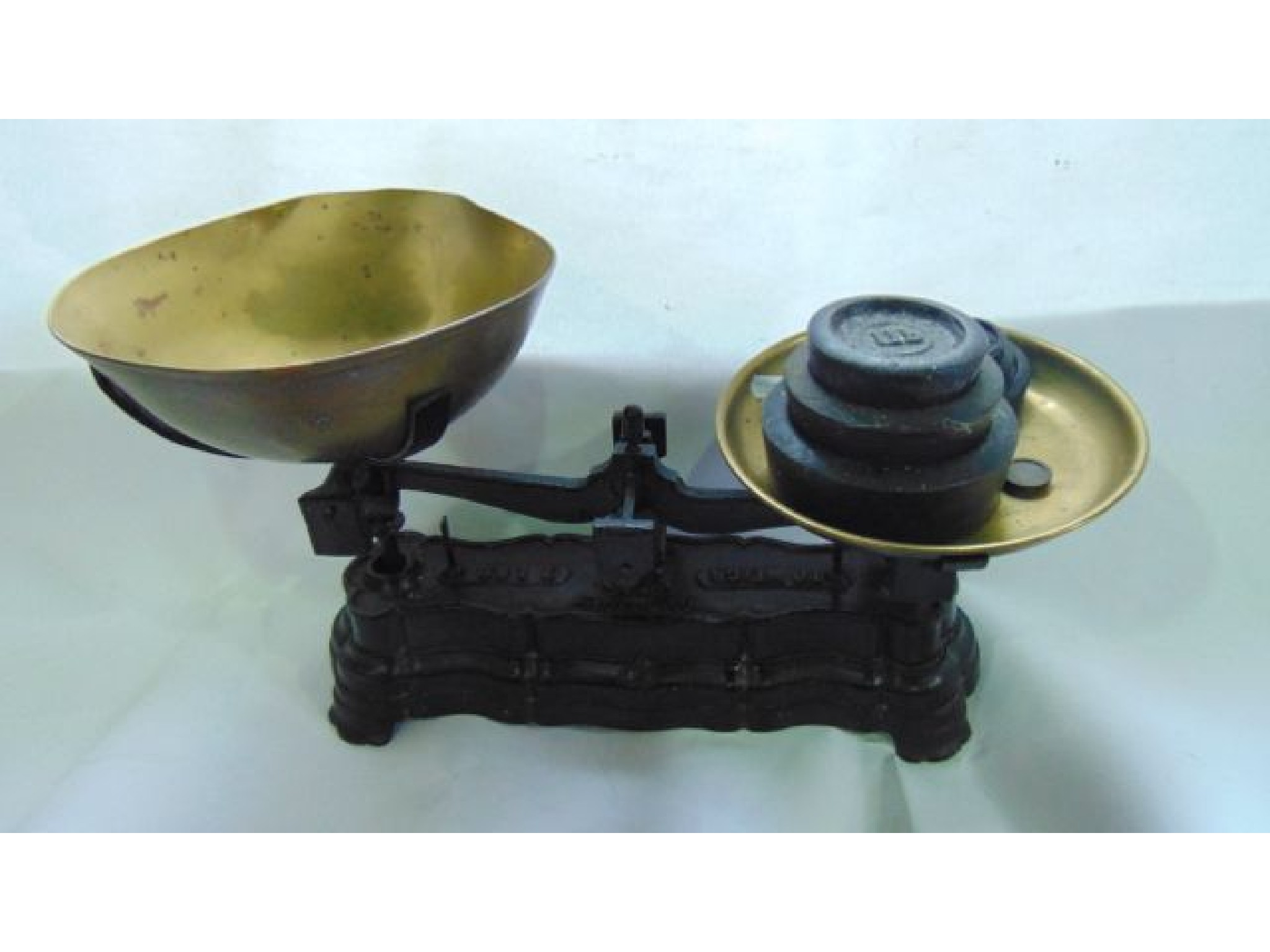 Appraisal: A vintage cast iron domestic scale assembly with brass bowls