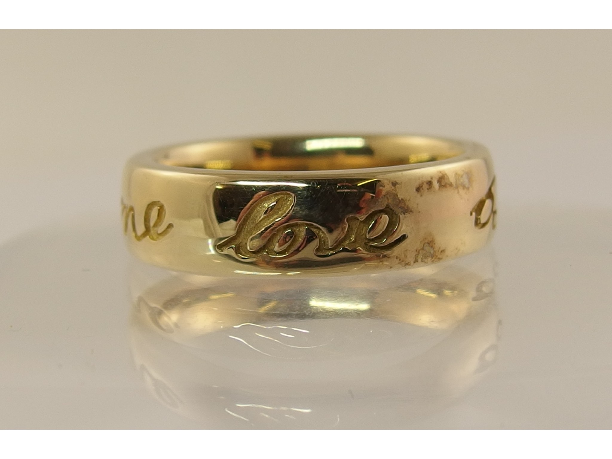 Appraisal: A ct Ola Gorie band ring engraved with 'Love to