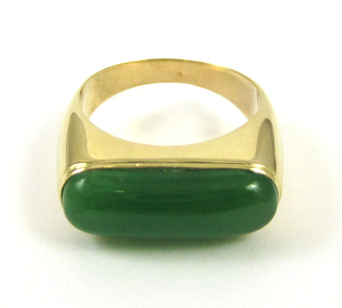 Appraisal: JADE AND FOURTEEN KARAT GOLD RING featuring an oval green