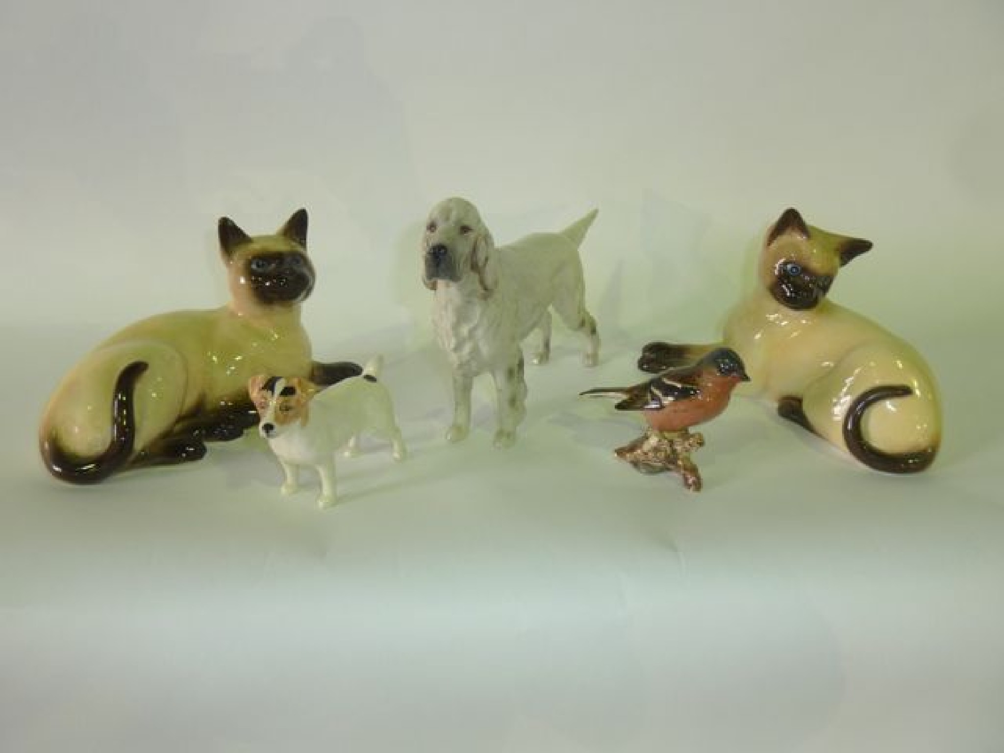 Appraisal: Two Beswick models of recumbent Siamese Cats with impressed numbers