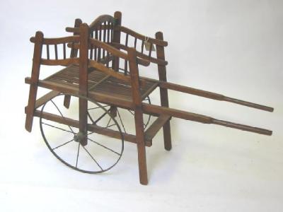 Appraisal: A miniature handcart in beech with turned and shaped sides