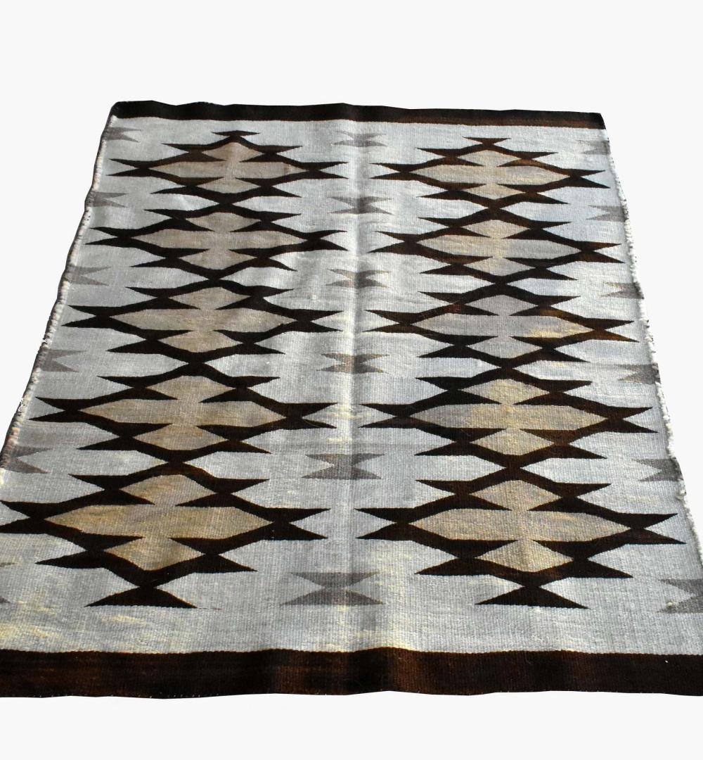 Appraisal: NAVAJO WOOL BLANKETDecorated with stylized motifs in tones of brown