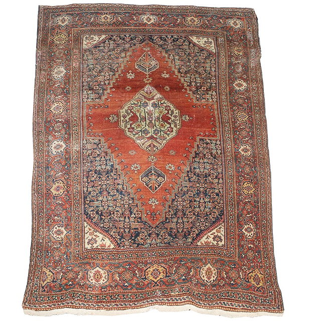 Appraisal: AN ANTIQUE PERSIAN FEREGHAN RUST GROUND RUG the central medallion