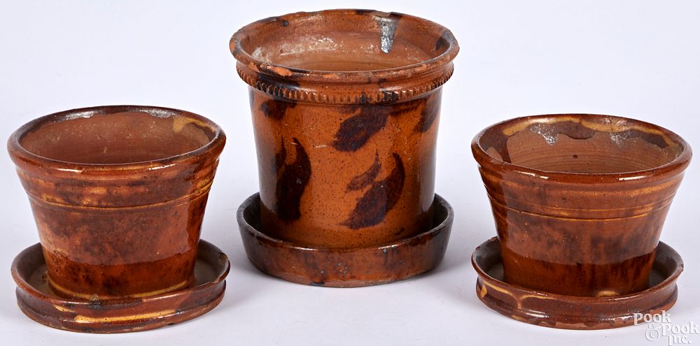 Appraisal: Three Pennsylvania redware flowerpots Three Pennsylvania redware flowerpots th c