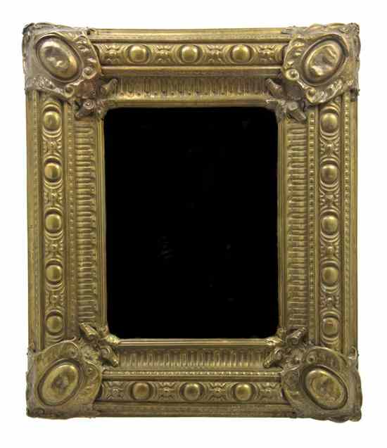 Appraisal: A Pressed Brass Mirror of rectangular form set with a