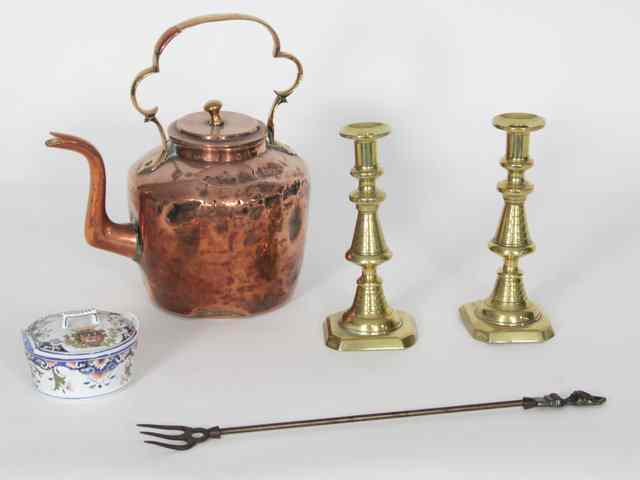 Appraisal: A pair of brass candlesticks copper kettle toasting fork and