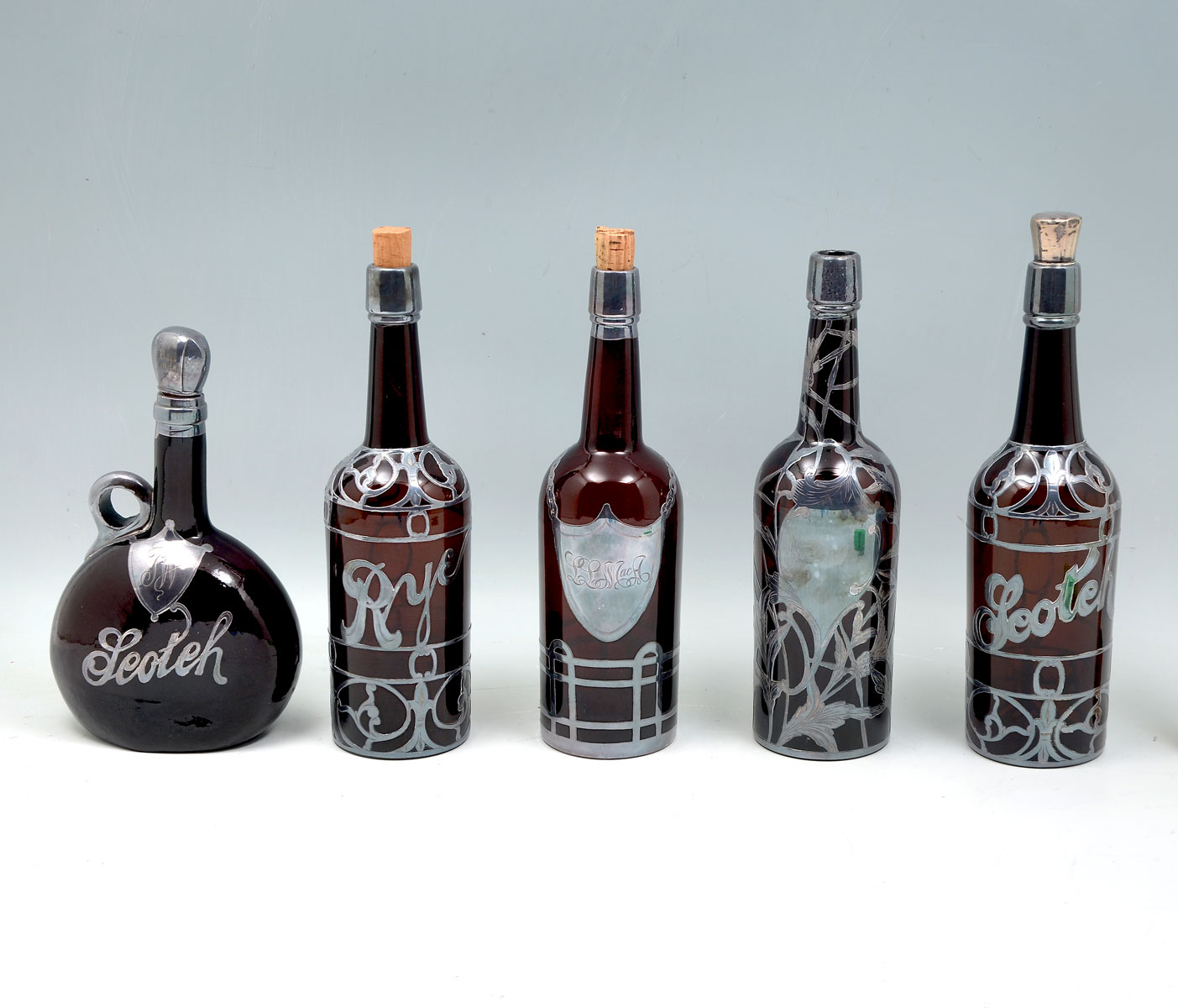 Appraisal: - PC BROWN GLASS STERLING OVERLAY BOTTLES Comprising - Scotch