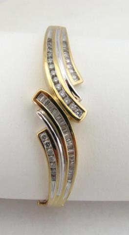 Appraisal: K Yellow gold hinged bangle bracelet with round and baguette