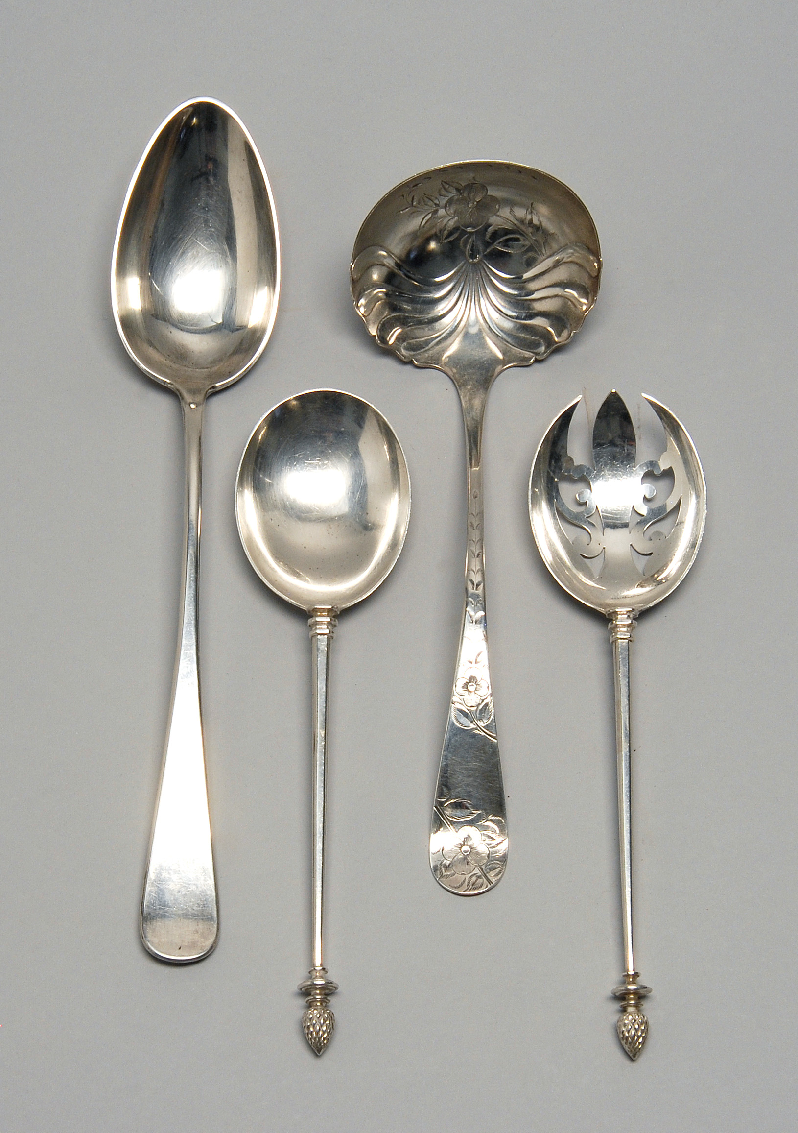 Appraisal: FOUR STERLING SILVER SERVING PIECES A stuffing spoon by Dominick