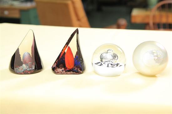 Appraisal: FOUR PAPERWEIGHTS Two sphere form weights with interior volcanic shafts