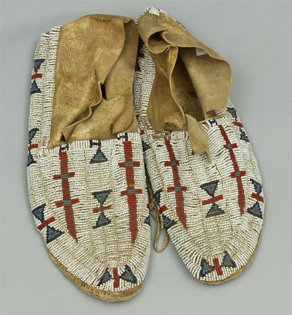 Appraisal: NATIVE AMERICAN BEADED HIDE MOCCASINS Central Plains circa multicolored geometric